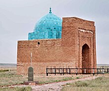 A large brick building with a round bright blue dome.